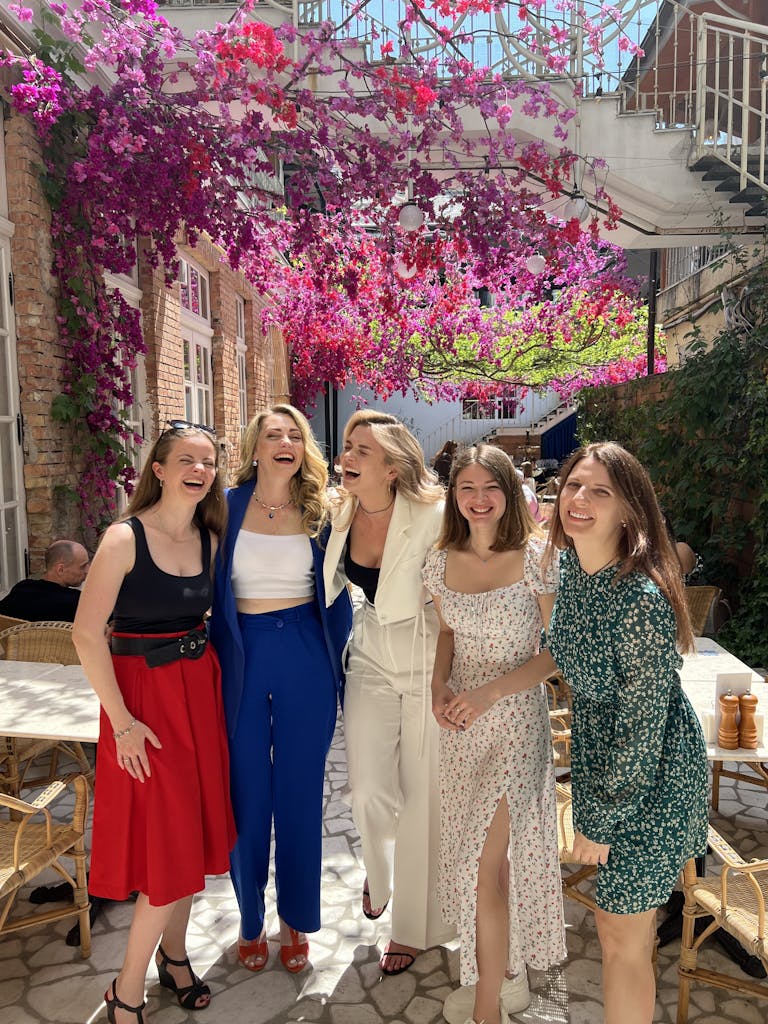 Four women standing together in front of a building