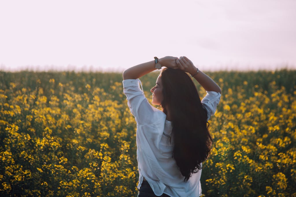 Woman Standing Near Yellow Flowers